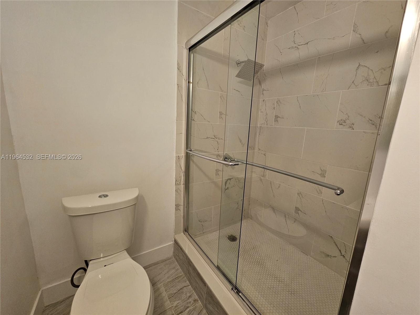 1727 Fletcher Street, Unit 1 Hollywood, FL 33020 - Photo 20 of 31 a bathroom with a toilet and a shower