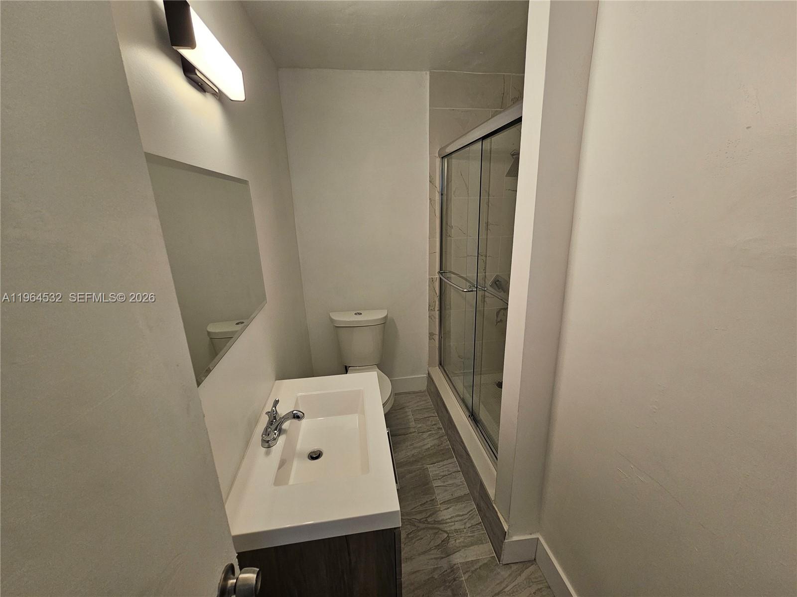 1727 Fletcher Street, Unit 1 Hollywood, FL 33020 - Photo 25 of 31 a bathroom with a sink a toilet and shower