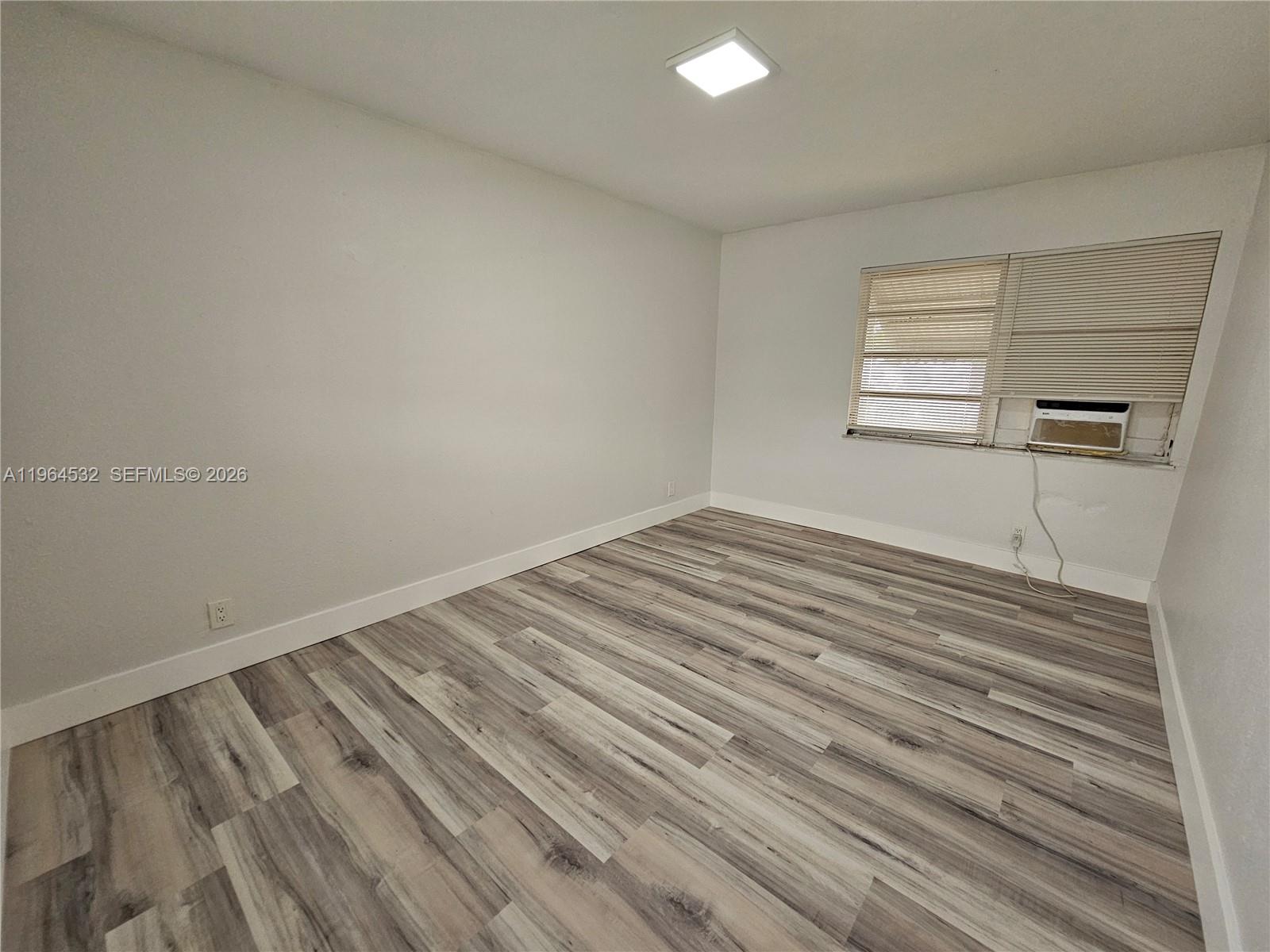 1727 Fletcher Street, Unit 1 Hollywood, FL 33020 - Photo 27 of 31 a view of empty room with wooden floor and fan
