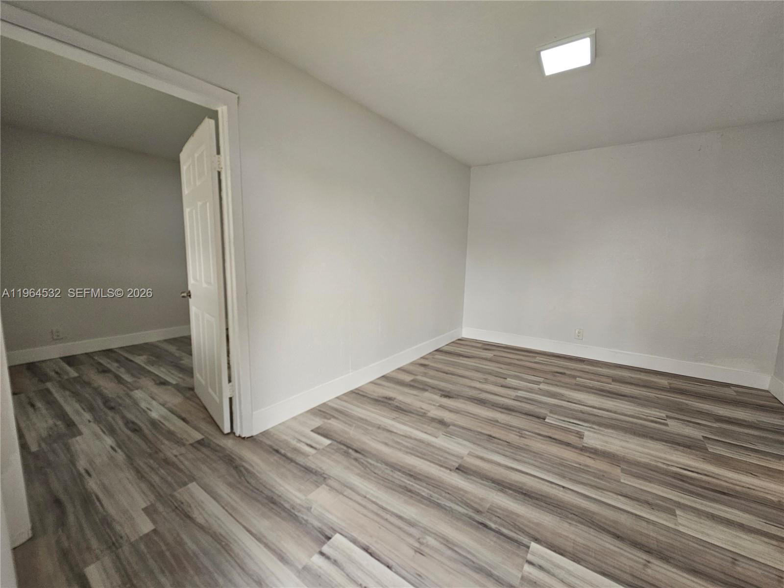 1727 Fletcher Street, Unit 1 Hollywood, FL 33020 - Photo 3 of 31 a view of empty room with wooden floor