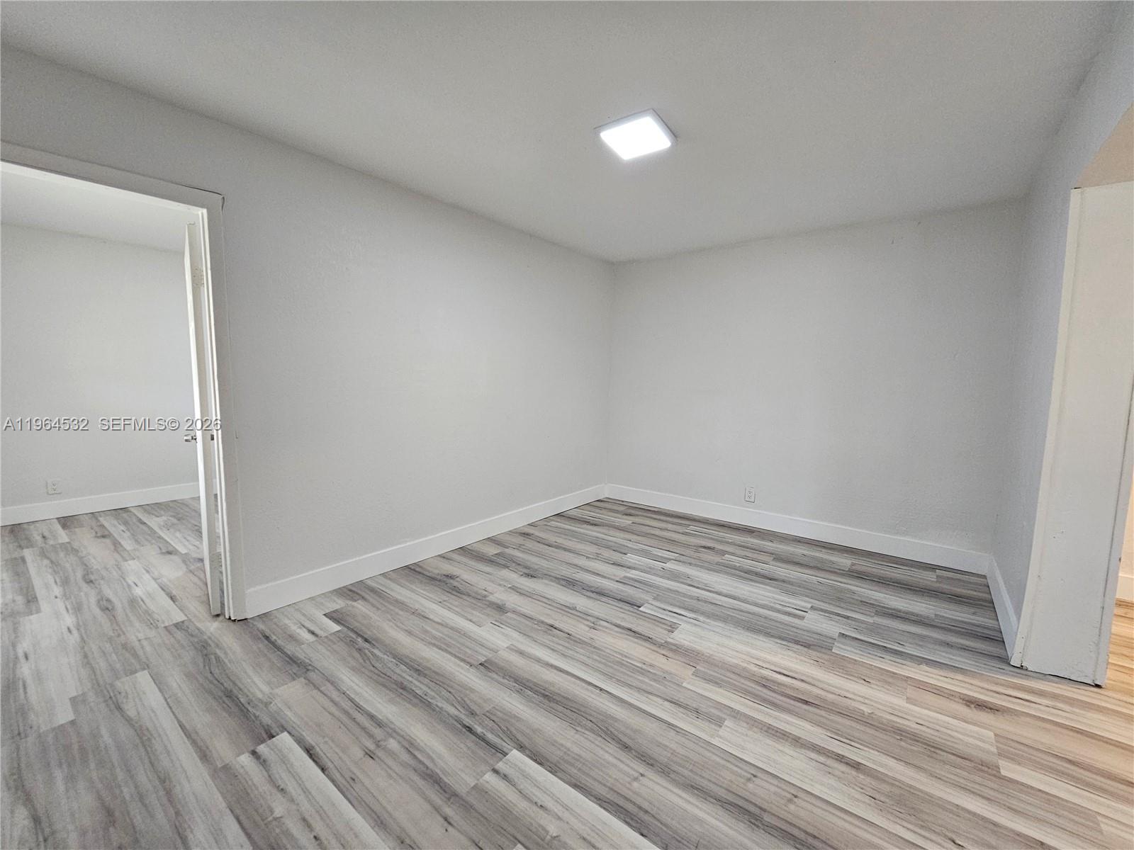 1727 Fletcher Street, Unit 1 Hollywood, FL 33020 - Photo 4 of 31 a view of empty room with wooden floor