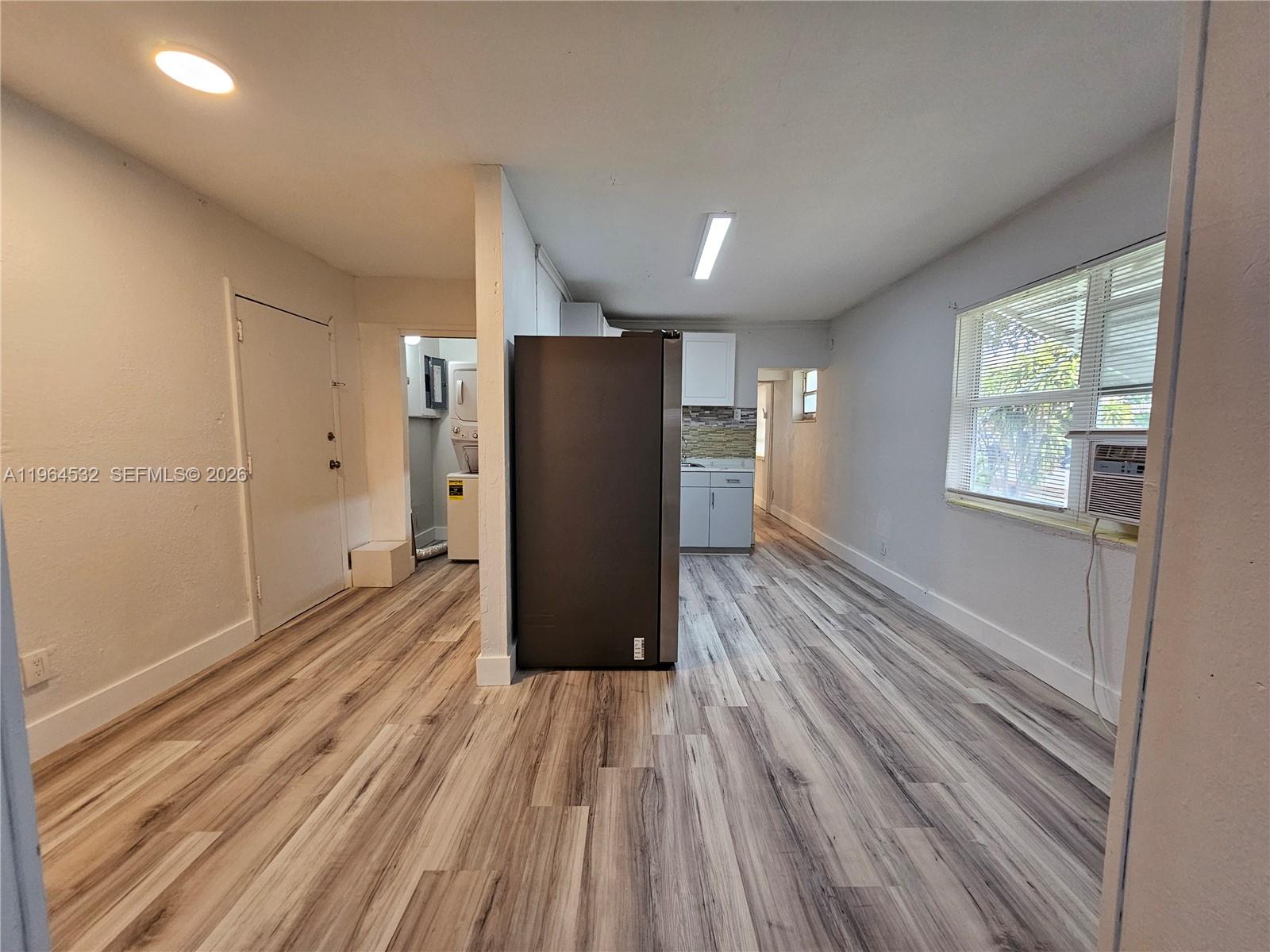 1727 Fletcher Street, Unit 1 Hollywood, FL 33020 - Photo 6 of 31 a view of a livingroom with wooden floor and a window