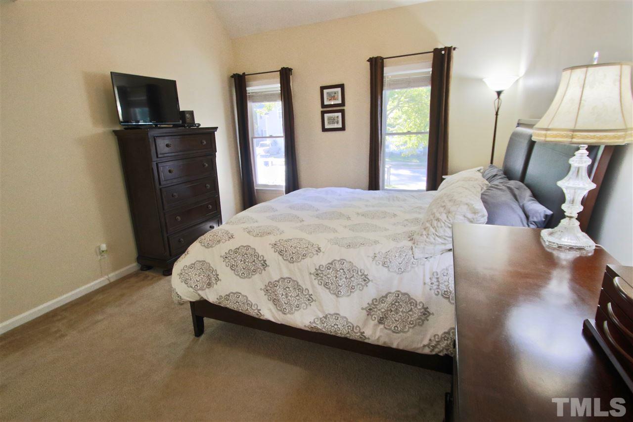 2349 Declaration Drive Raleigh, NC 27615 - Photo 14 of 25 a bedroom with a bed and a flat screen tv