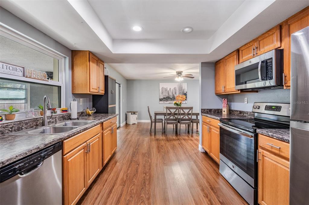 18631 San Rio Circle Lutz, FL 33549 - Photo 2 of 39 a kitchen with stainless steel appliances wooden floors stove and granite top