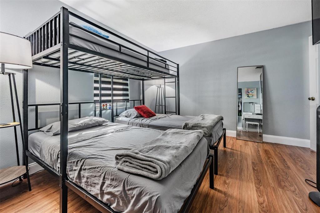 18631 San Rio Circle Lutz, FL 33549 - Photo 24 of 39 a bed sitting in a bedroom next to a window with wooden floor