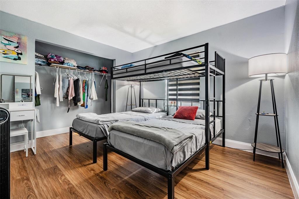 18631 San Rio Circle Lutz, FL 33549 - Photo 25 of 39 a bedroom with a bed a mirror and desk