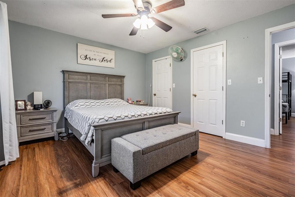 18631 San Rio Circle Lutz, FL 33549 - Photo 29 of 39 a bedroom with a bed and a chandelier