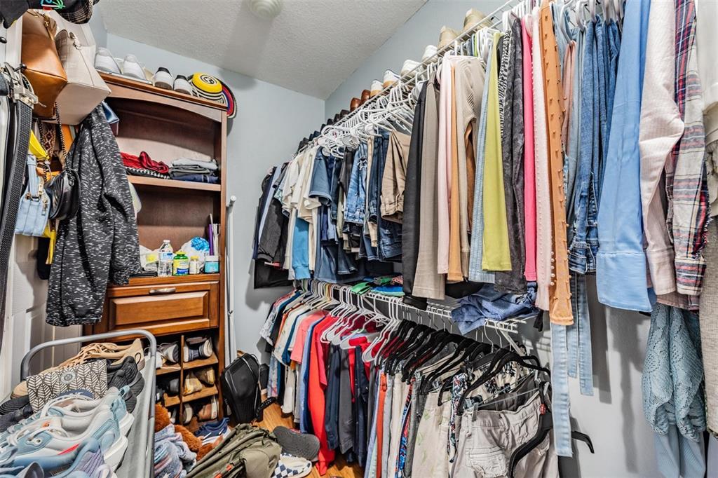 18631 San Rio Circle Lutz, FL 33549 - Photo 30 of 39 a view of walk in closet with clothes and shoes