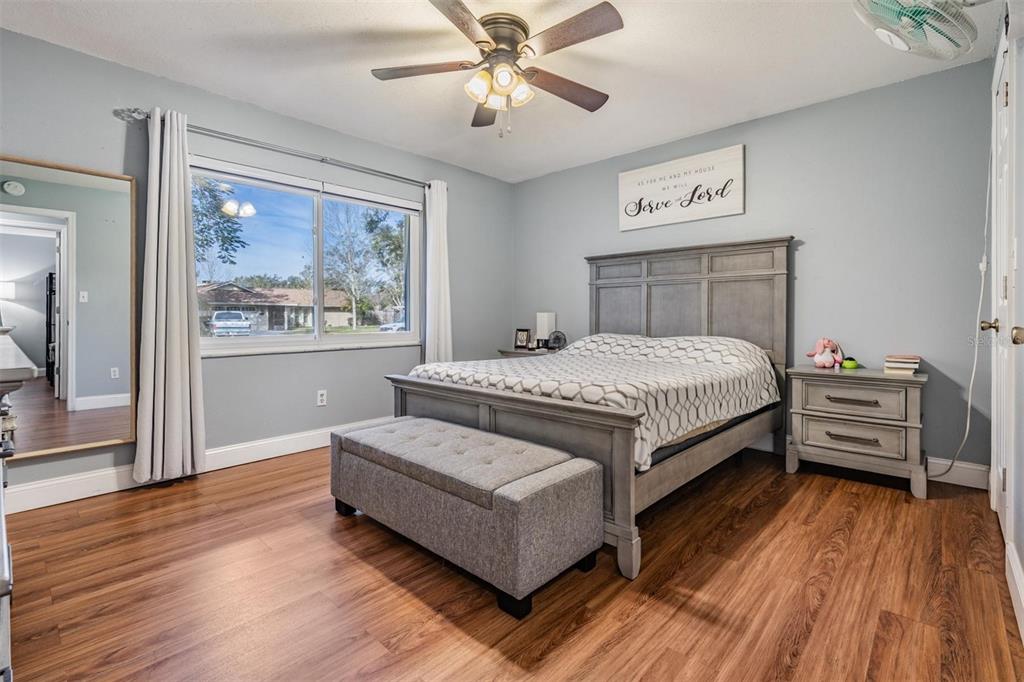18631 San Rio Circle Lutz, FL 33549 - Photo 31 of 39 a bedroom with a bed wooden floor and window