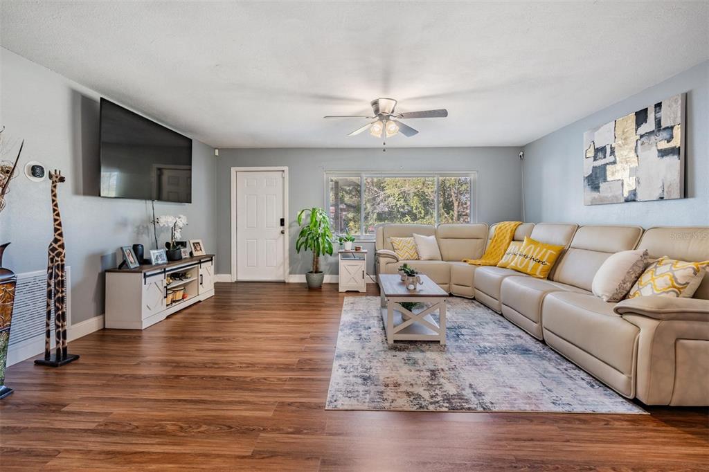 18631 San Rio Circle Lutz, FL 33549 - Photo 5 of 39 a living room with furniture wooden floor and a flat screen tv