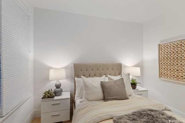 a bedroom with a bed and cabinets