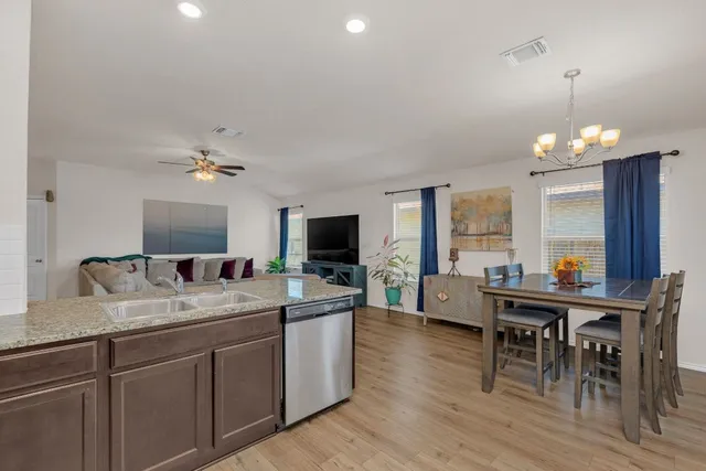 a large kitchen with a table and chairs