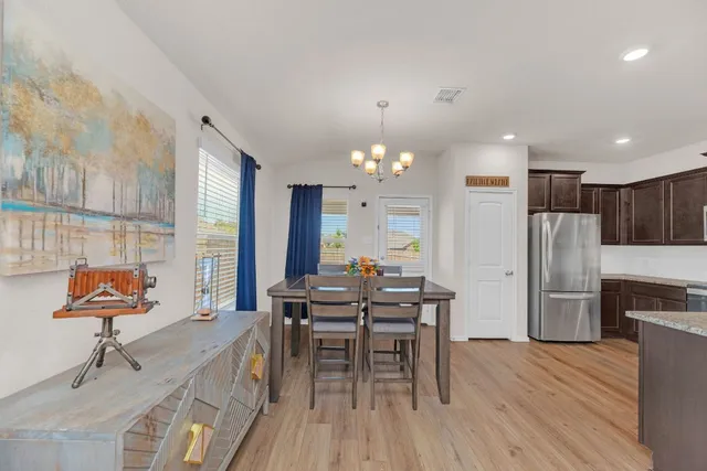 a view of a dining room with furniture and wooden floor