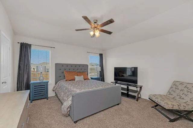 a bedroom with a bed and a television