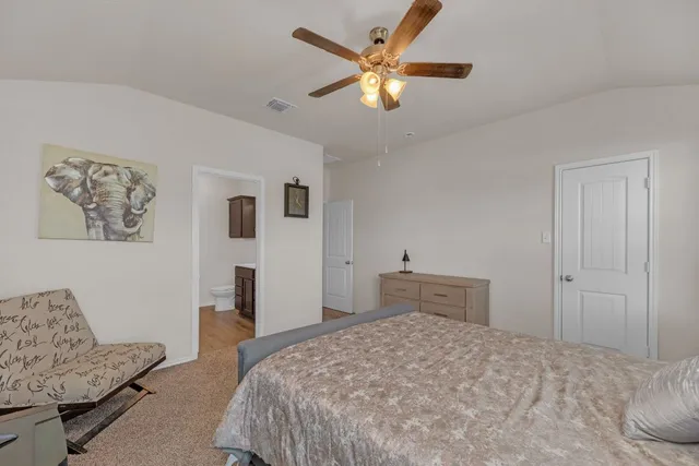 a bedroom with a bed and a couch