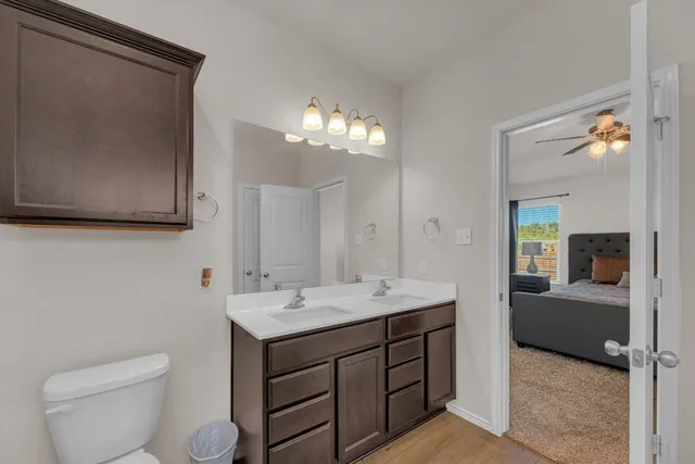 a bathroom with a sink a toilet and mirror