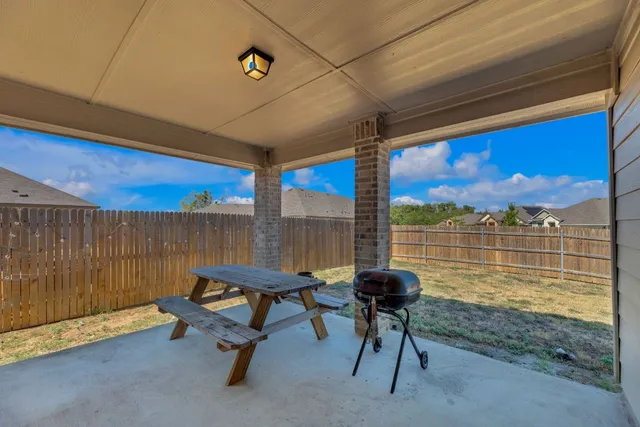 a view of a chairs and table in patio