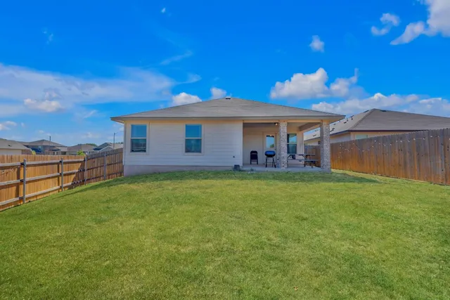 a view of a house with a backyard