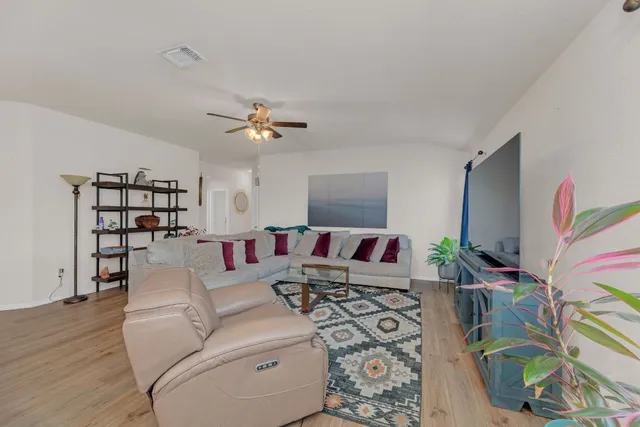 a living room with furniture a rug and a flat screen tv