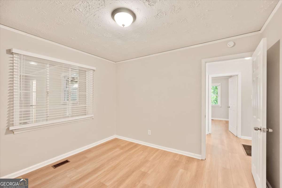 752 Jefferson Avenue Southwest Atlanta, GA 30315 - Photo 14 of 30 an empty room with wooden floor and windows