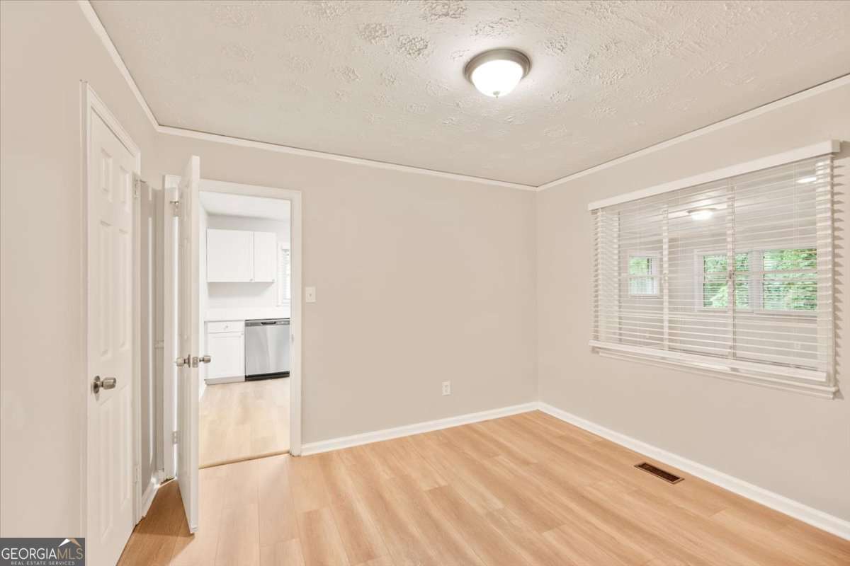 752 Jefferson Avenue Southwest Atlanta, GA 30315 - Photo 15 of 30 a view of an empty room with wooden floor and a window