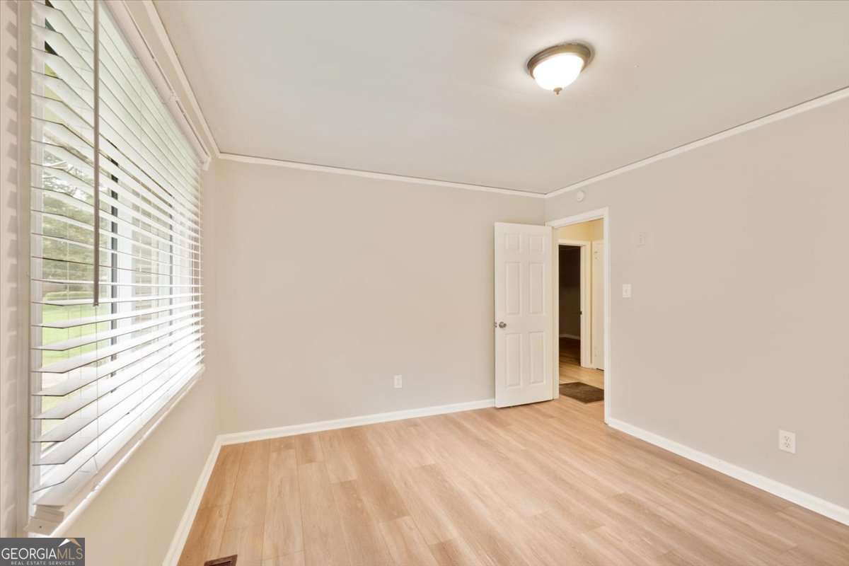 752 Jefferson Avenue Southwest Atlanta, GA 30315 - Photo 17 of 30 a view of an empty room with a window and wooden floor