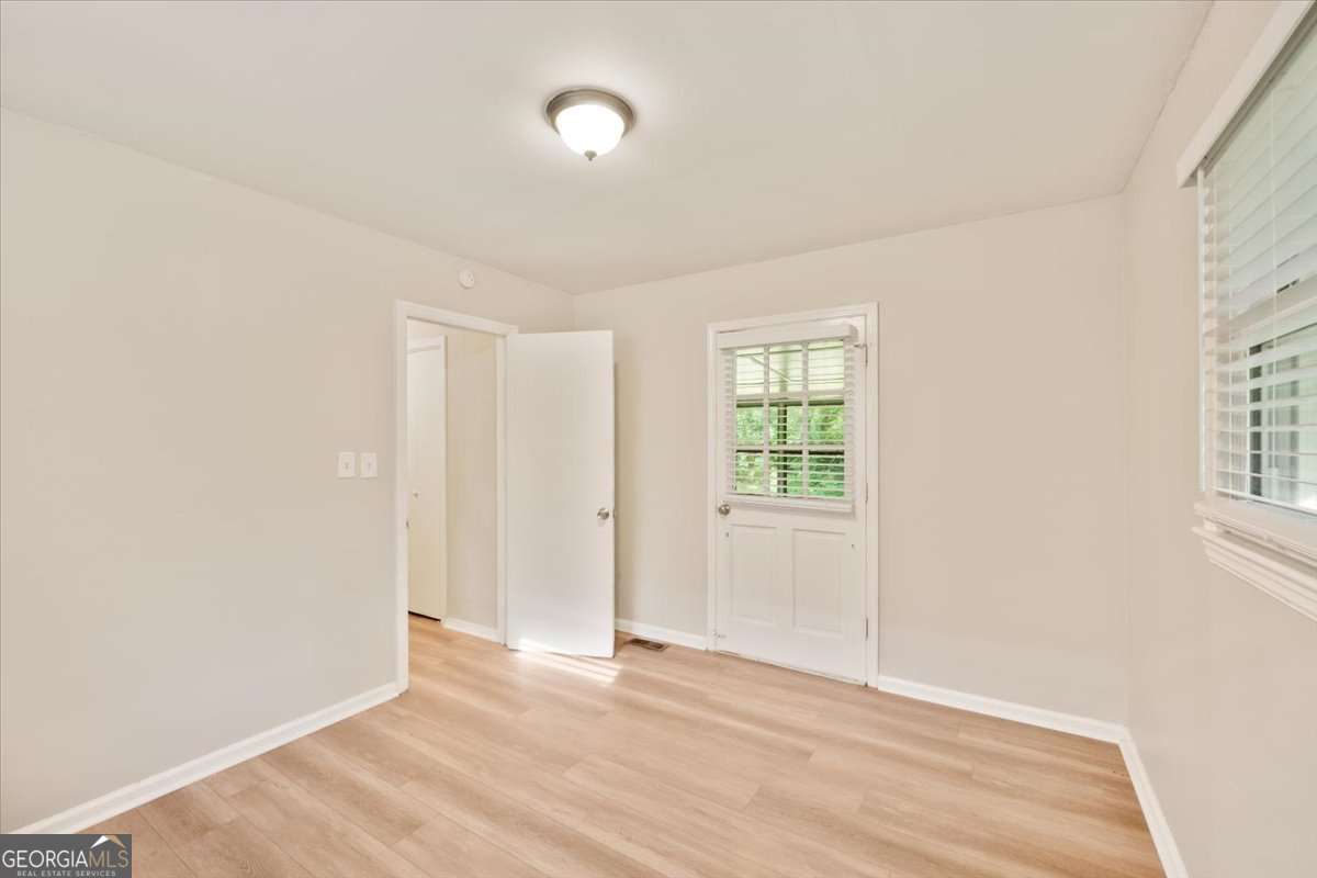 752 Jefferson Avenue Southwest Atlanta, GA 30315 - Photo 22 of 30 an empty room with wooden floor and windows