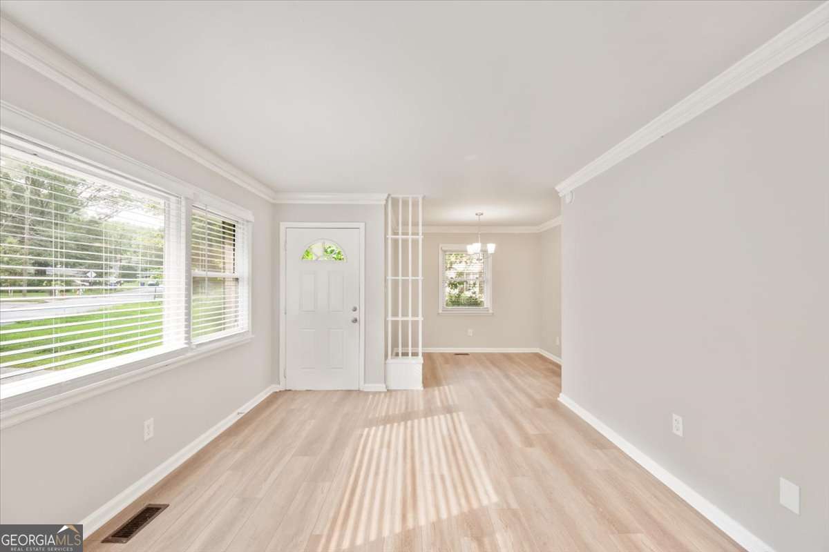 752 Jefferson Avenue Southwest Atlanta, GA 30315 - Photo 5 of 30 a view of an empty room with wooden floor and a window