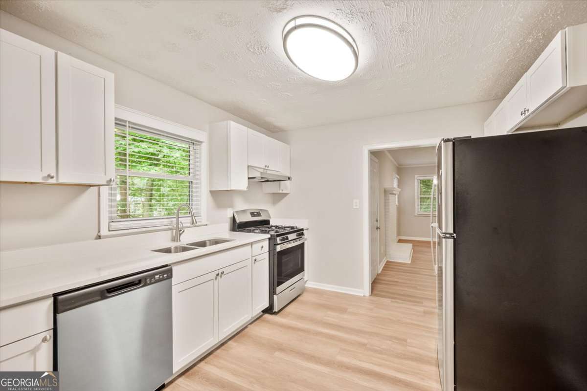 752 Jefferson Avenue Southwest Atlanta, GA 30315 - Photo 7 of 30 a kitchen with a stove a sink and a window