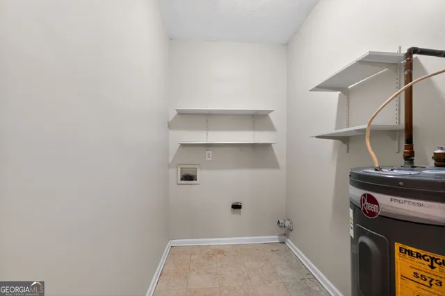 a view of storage and utility room with closet