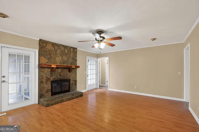 a view of an empty room with a fireplace and a window