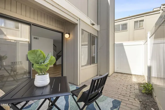 a vase of flowers sitting on a table in front of a window