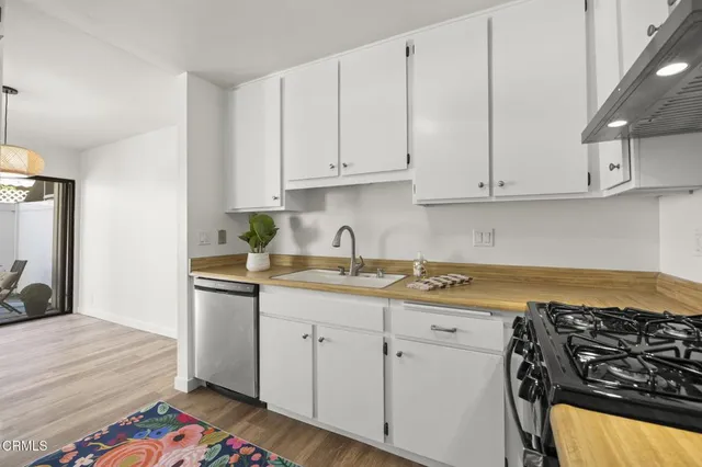 a kitchen with granite countertop a sink and cabinets