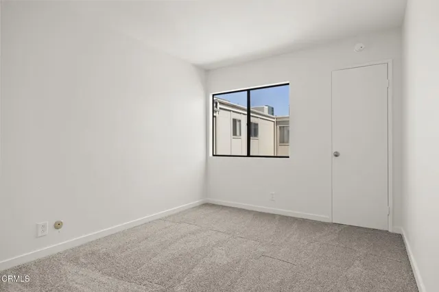 a view of an empty room with windows