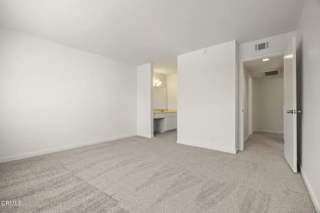 a view of an empty room and a window