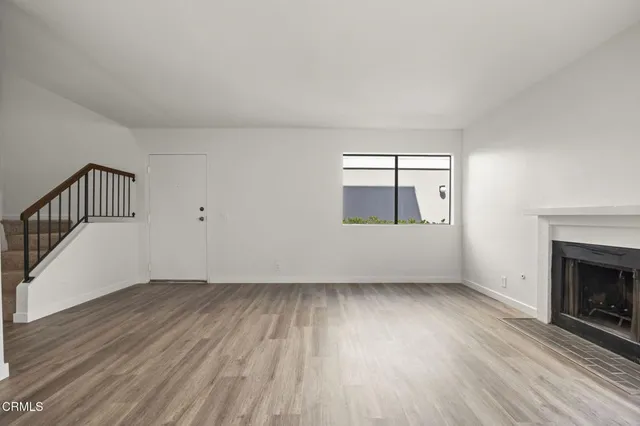 wooden floor in an empty room with a fireplace