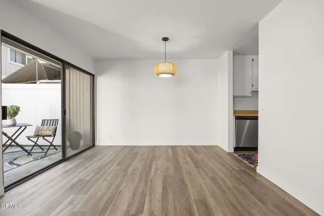 a view of a livingroom with wooden floor and a window