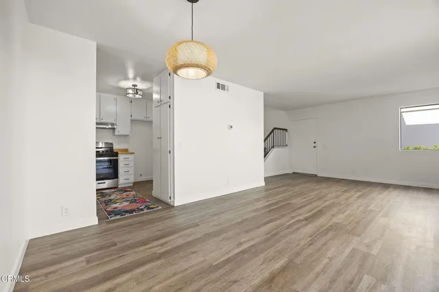 a view of empty room with wooden floor