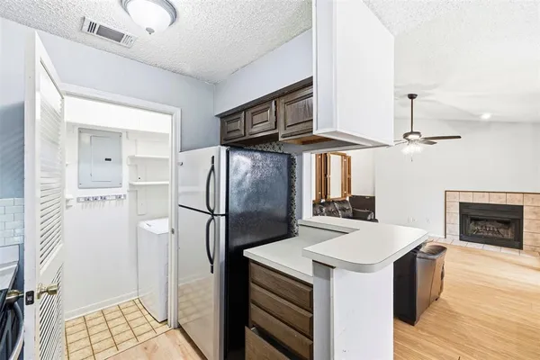 a kitchen with stainless steel appliances a stove a refrigerator and a fireplace