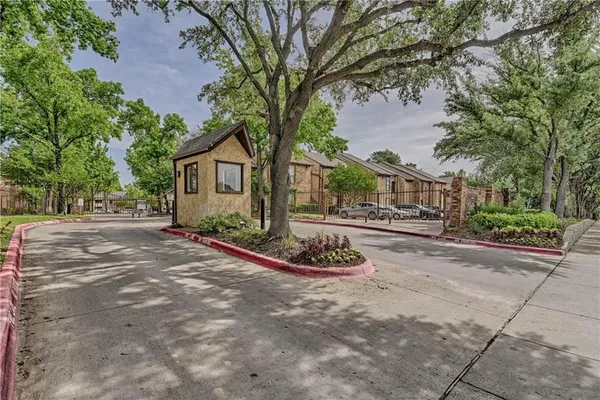 a front view of a house with a yard and tree s