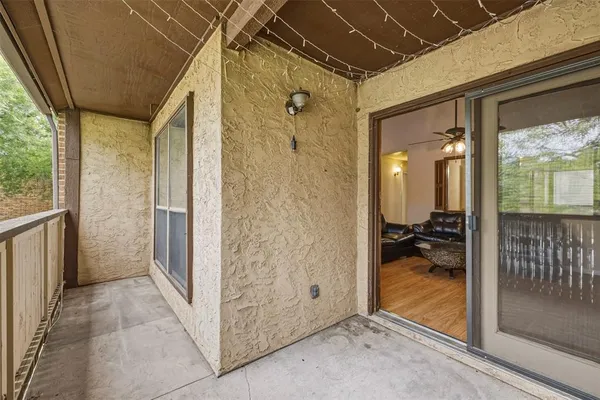 a view of a hallway with a livingroom and entryway