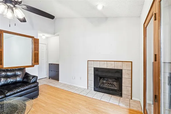 a living room with furniture a fireplace and a chandelier