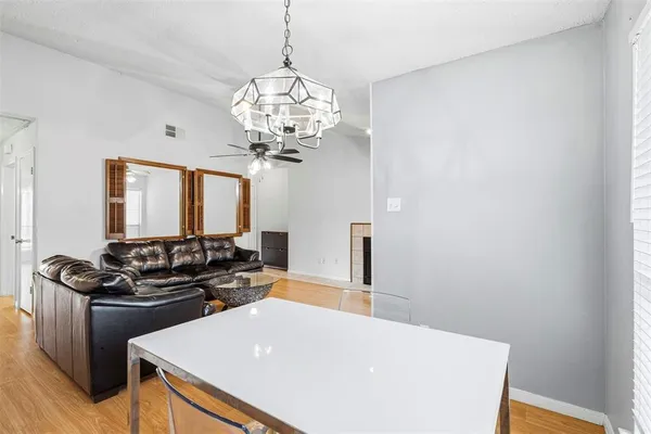 a kitchen with stainless steel appliances a chandelier