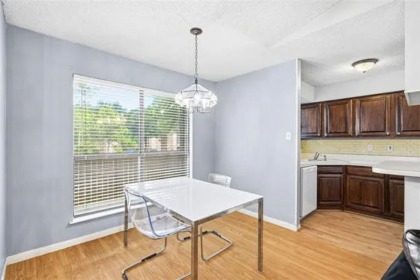 a view of a kitchen area with furniture window and wooden floor