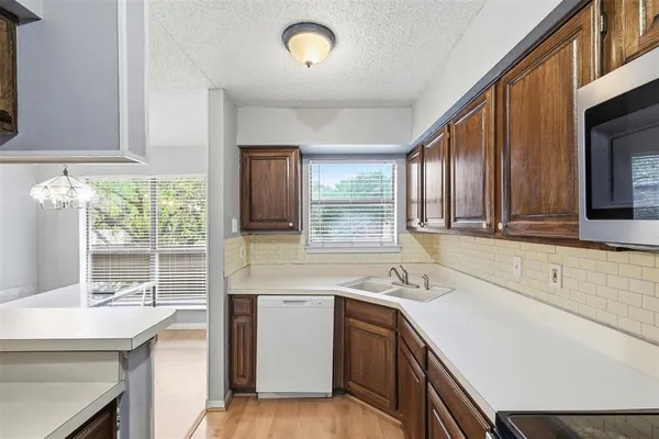 a kitchen with a sink stove and cabinets
