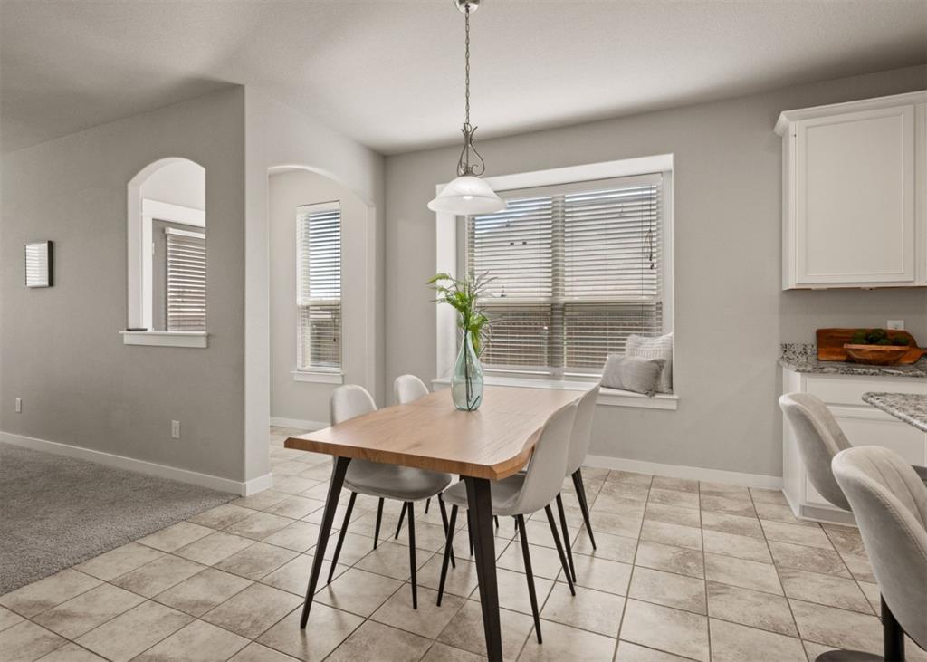 2521 Boot Jack Road Fort Worth, TX 76177 - Photo 11 of 40 a kitchen with stainless steel appliances kitchen island granite countertop a table and chairs in it