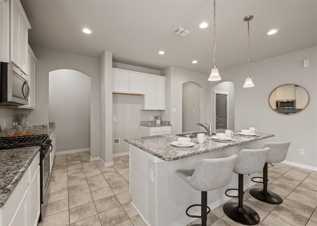 2521 Boot Jack Road Fort Worth, TX 76177 - Photo 12 of 40 a kitchen with stainless steel appliances granite countertop a sink a stove a refrigerator a dining table and chairs