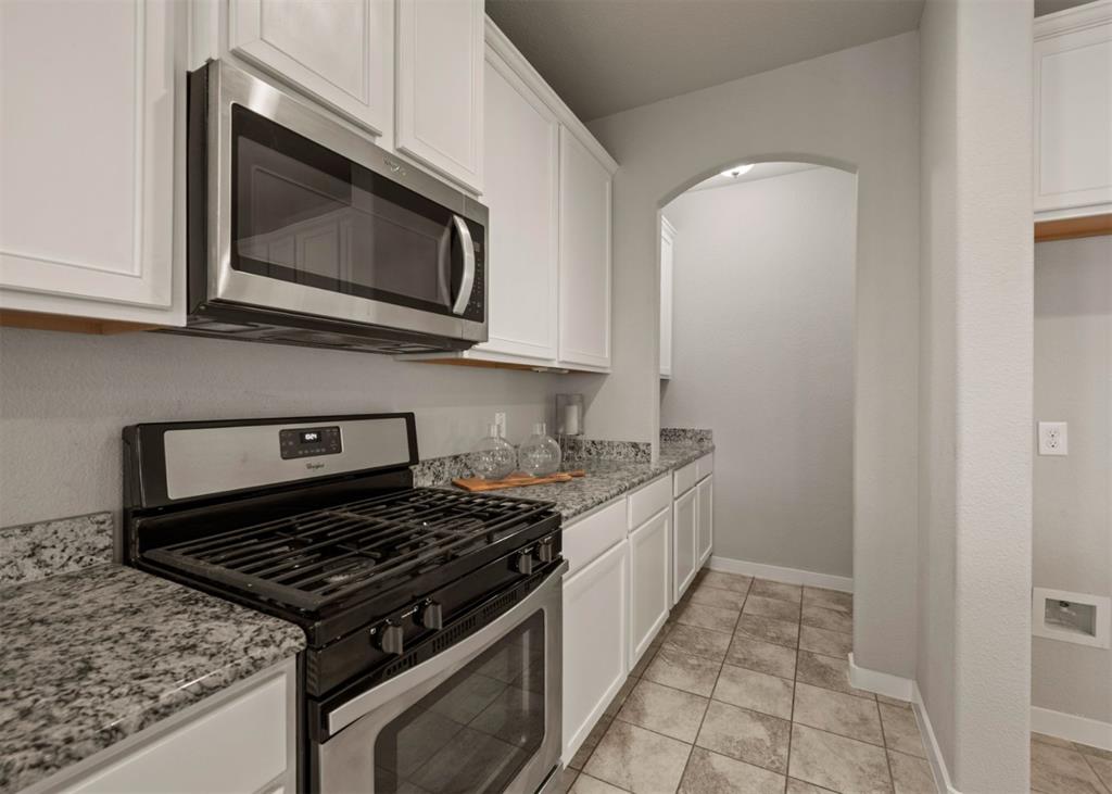 2521 Boot Jack Road Fort Worth, TX 76177 - Photo 13 of 40 a kitchen with a stove and a microwave