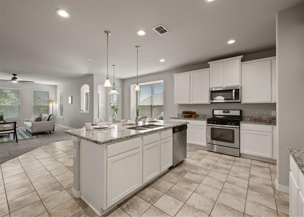 2521 Boot Jack Road Fort Worth, TX 76177 - Photo 16 of 40 a kitchen with stainless steel appliances granite countertop a stove top oven a sink a counter top space and cabinets