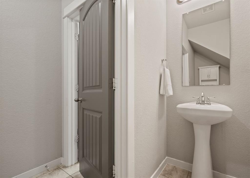 2521 Boot Jack Road Fort Worth, TX 76177 - Photo 18 of 40 a bathroom with a sink a mirror and toilet